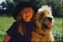 Девочка в шляпе с лохматым псом
