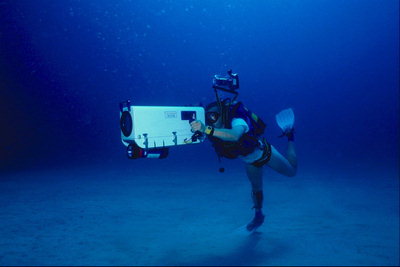Diver with a camera for underwater shooting