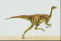 Динозавр светло-салатового цвета в бордовых полосках на спине