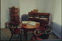 Офис. Круглый стол, кресло, деревянные стулья, шкаф для книг и документов