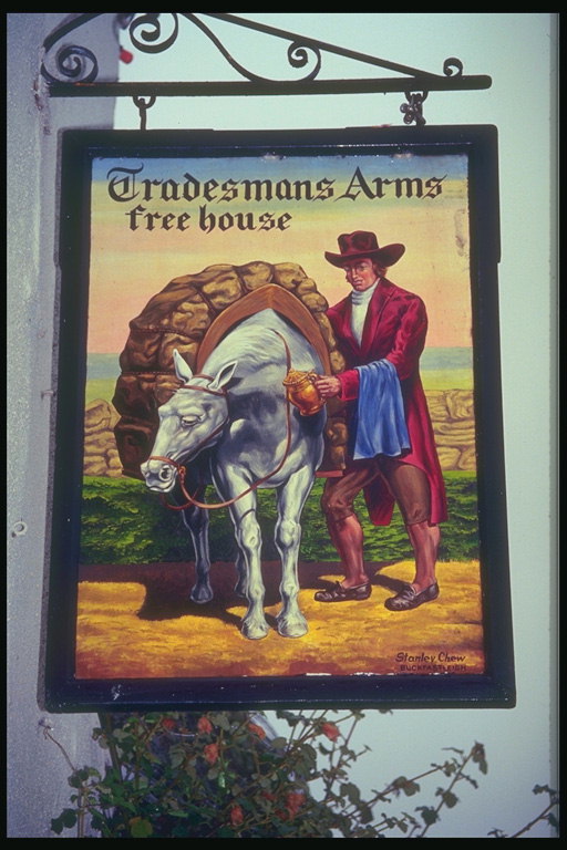 Signboard representado homes e cabalos contra o Pano de fondo de un campo
