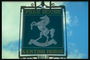 Signboard dark green color with the image of a white horse