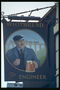 A man with a mug of beer at a railroad