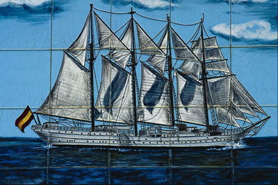 A ship with white sails