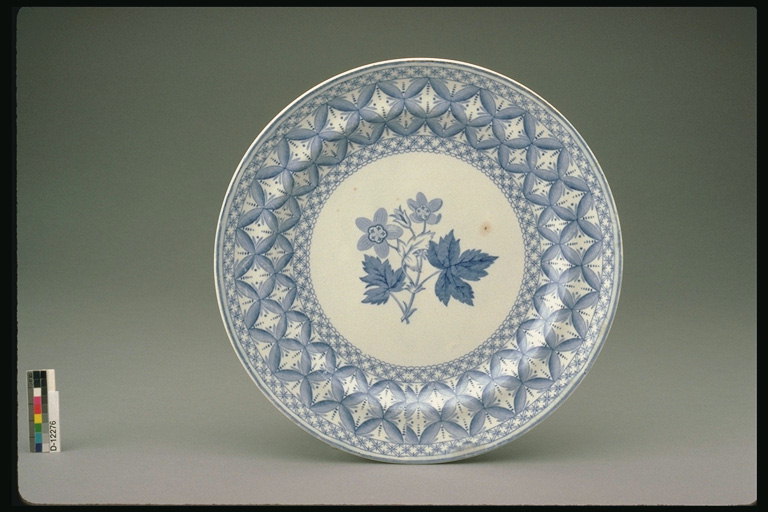 Plate with a branch of flowers with leaves