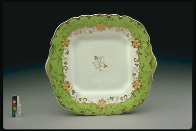 Saucer with curly edges and light green ornament