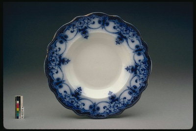 Plate with curly edges. Dark blue pattern