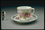 Cup and saucer with drawings of roses