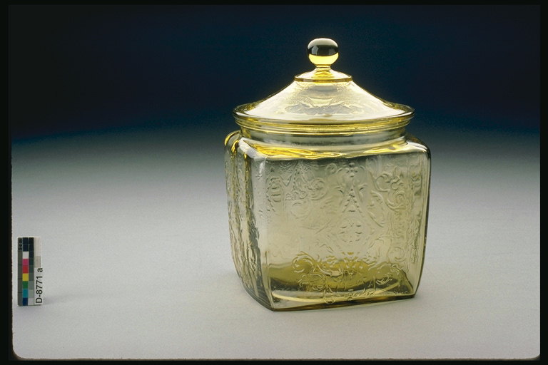 A large glass container with lid