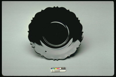 Saucer with black glasses with curly edges