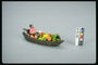 Деревяная лодка с продуктами и человеком внутри