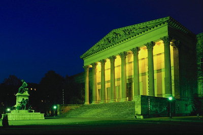 The structure with columns in the green light of night lights
