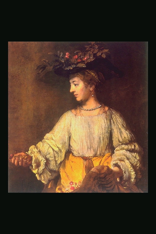 Μια γυναίκα σε ένα καπέλο με υποκαταστήματα και μούρα