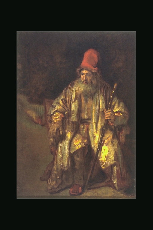 O velho homem em um vestido amarelo com um pau na mão.