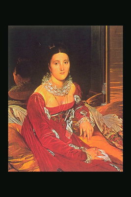 Një grua në një fustan të kuq mbi krevat