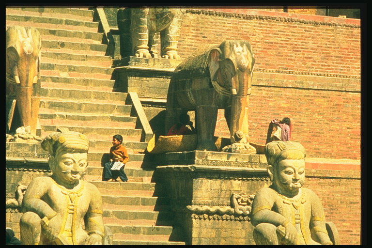 Estátuas de homens, elefantes nas escadas