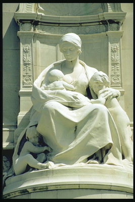 A woman breastfeeding a child in white marble
