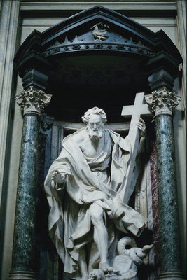 Elderly man with a cross in the hands of