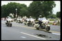 Полицейские на мотоциклах едут по улице