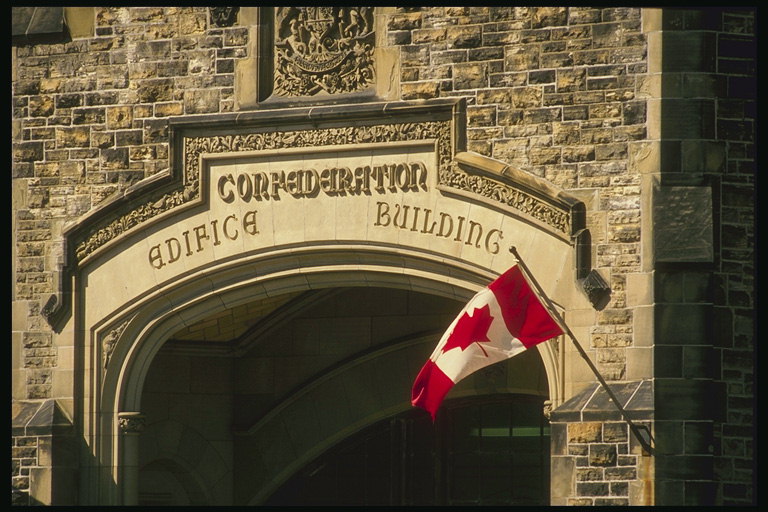 Вход в здание канадской конфедерации. Канадский кленовый флаг на государственном учреждении