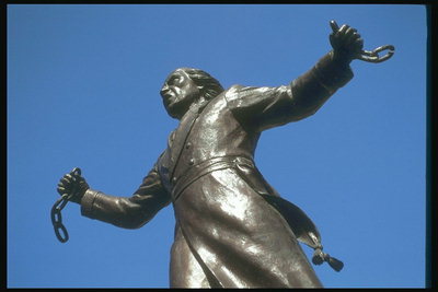 Статуя мужчины как символ раба, который рвёт цепи и выходит на свободу