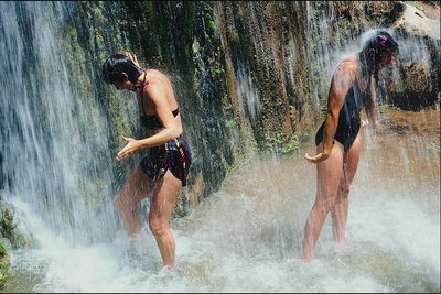 Bathing persons, under the waterfall