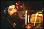 Человек молящийся в храме у алтаря со свечами