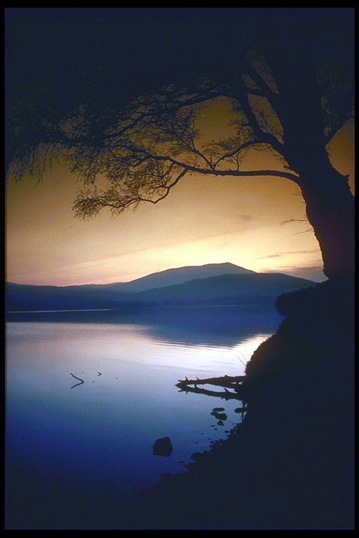 Голубой закат над озером и горной долиной 