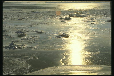 Winter river. Sun glare