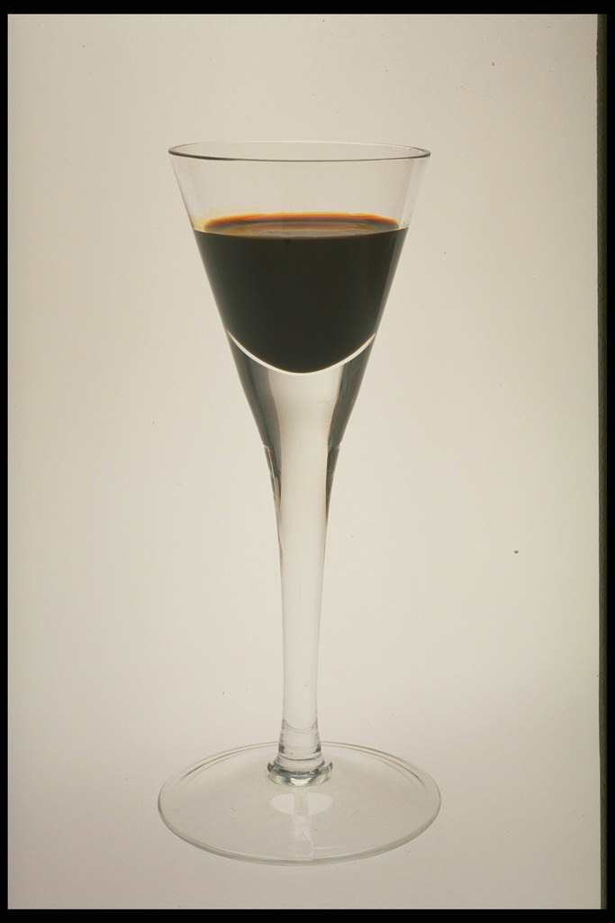 Drikk en mørk farge i glasset på en lang stilk