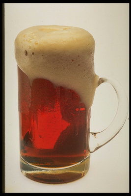Thick foam on the glass with beer
