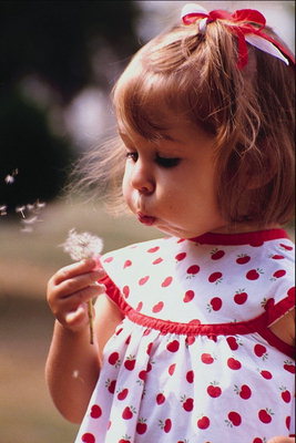 Girl blow dandelion