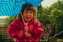 Dívka v červeném kurtochke s deštníkem
