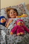 Girl in bed with toys