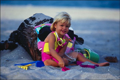 Egy kislány játszik a homokozóban