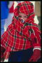 A little boy trong checkered khăn muffled