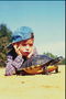 A boy in jeans cap memonitor turtle