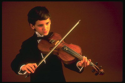 The boy plays the violin