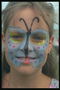 Butterfly painted on the face of the girl