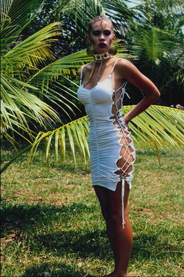 A girl in a white dress with lacing