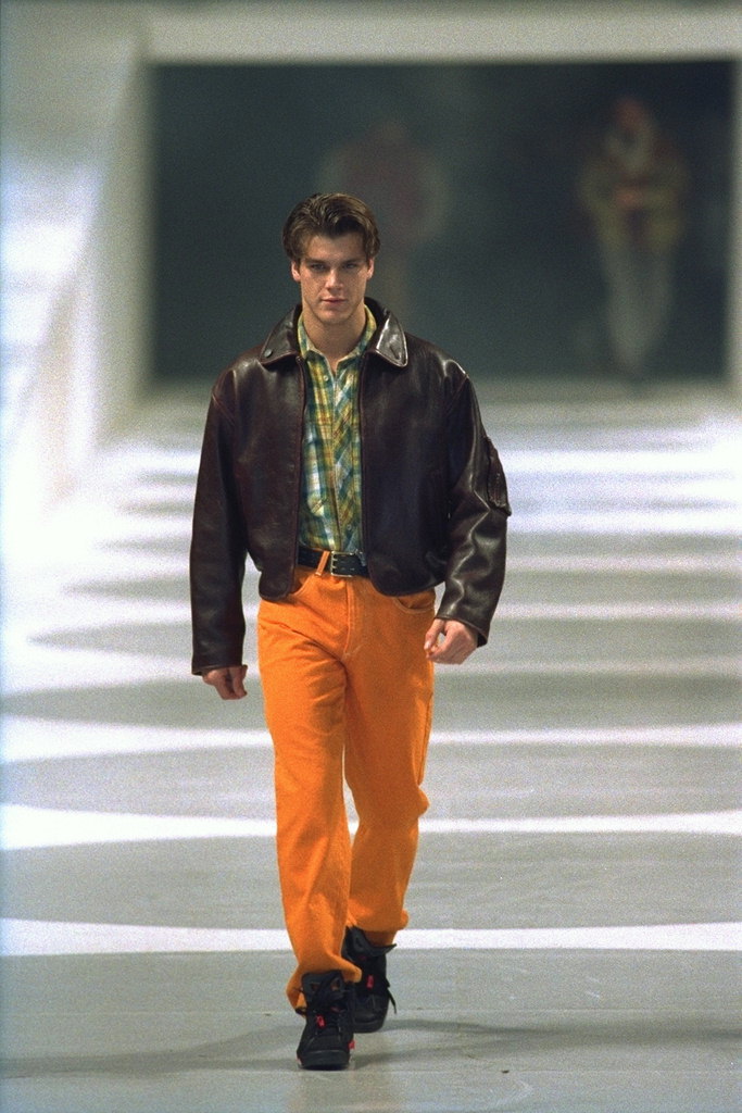 The orange pants and brown leather jacket