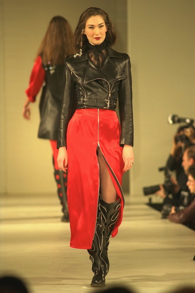 Red skirt in front of Snake. Short leather jacket