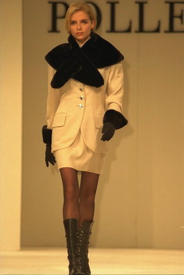 The costume of cream tones with black cuffs and collar