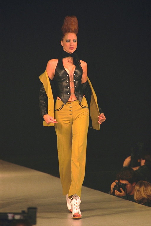 Leather Vest and mustard-colored trousers