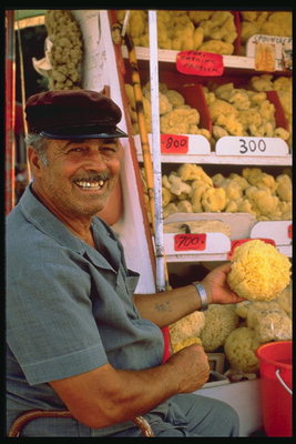A man near the counter with vegetables