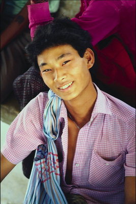 Young man in shirt-sleeves in small box of pink color