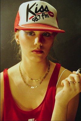Girl with a cigarette in caps