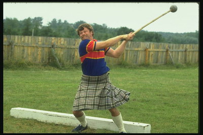 Sports. A man in a gray plaid throws the hammer