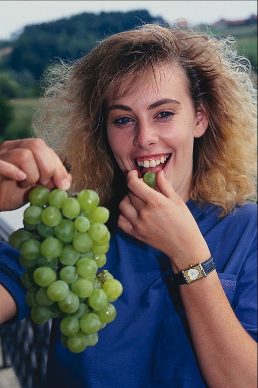 Girl with a sprig of grapes