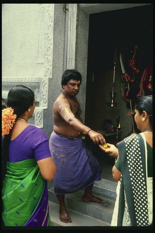 A man in a purple skirt with drawings on the body